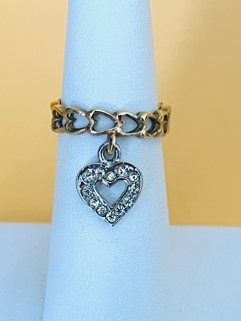 Gold plated ring with dangling heart size 5, chain link design